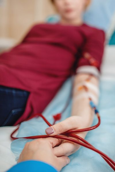 Young beautiful girl, during hemodialysis in hospital, dialysis system equipment, habitual routine for chronic patient, lifestyle, medical concept