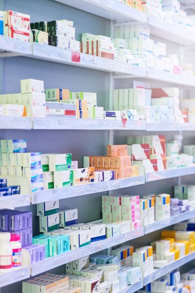 Pharmacy, shelf and boxes for product, empty or pharmaceutical stock for wellness, health and interior. Shop, store and retail healthcare with storage, choice or sale for wellness, discount and drugs
